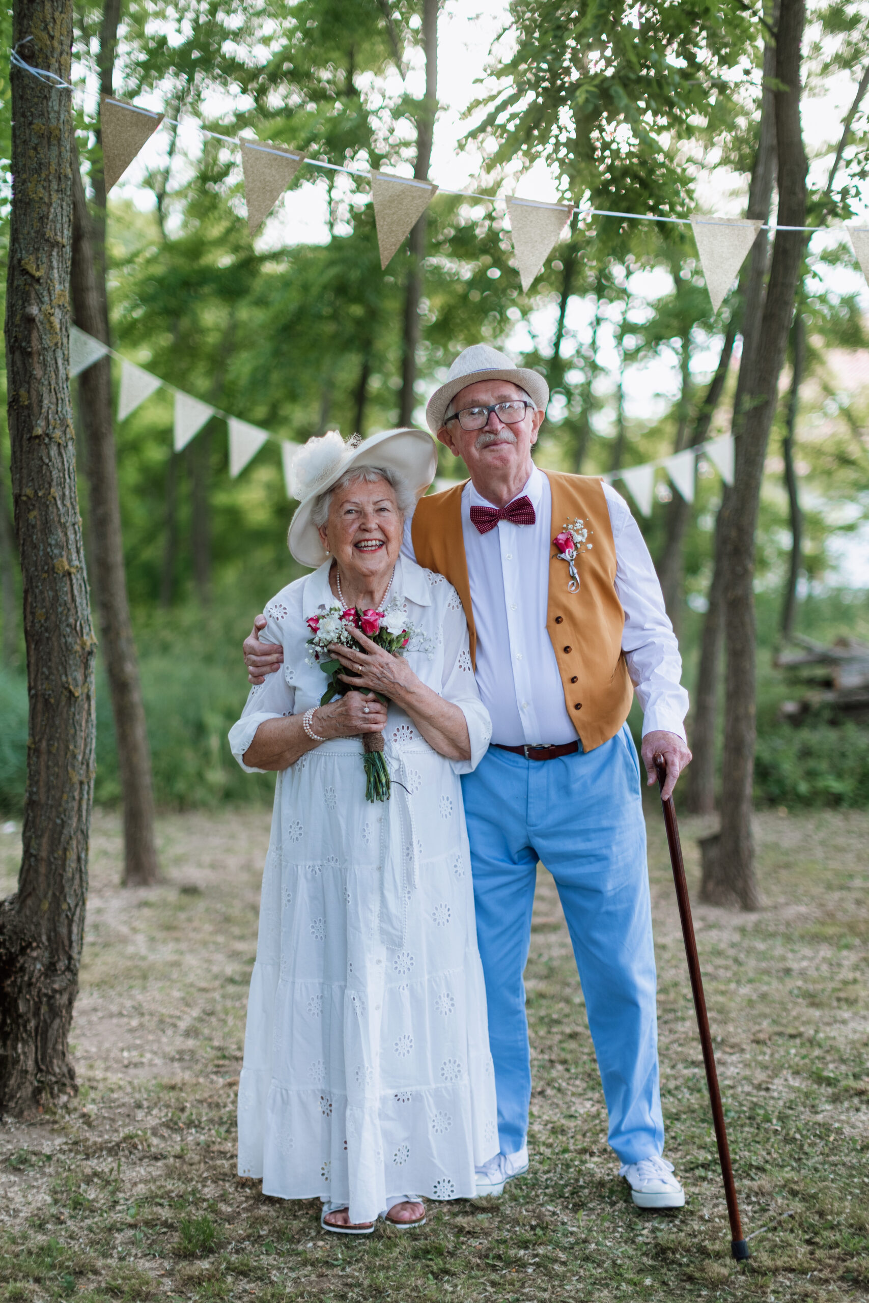 Senior couple having marriage in nature during summer day.
